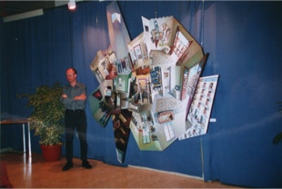 View of Paul Critchley with the painting 'Rauric 12' in the Palais des Congrès, Lourdes