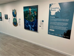 Creative Roots Exhibition view with shaped painting by Paul Critchley