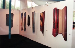 Stand view of Galerie Maas, with shaped, diptych and triptych paintings by Paul Critchley