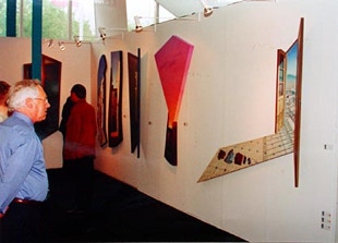 Stand view of Galerie Maas, with shaped, diptych and triptych paintings by Paul Critchley